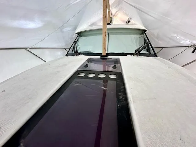  Yacht Photos Pics 2019 Beneteau Antares 27 boat under protective cover, showcasing front deck and windshield.