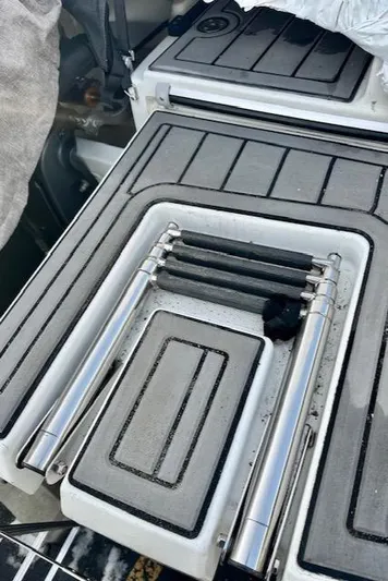  Yacht Photos Pics Beneteau Antares 27 (2019) boat deck with foldable ladder and storage compartments.