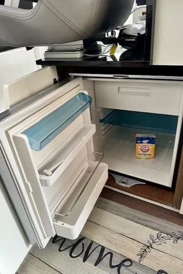  Yacht Photos Pics Open refrigerator inside 2019 Beneteau Antares 27 boat, with Arm & Hammer baking soda.