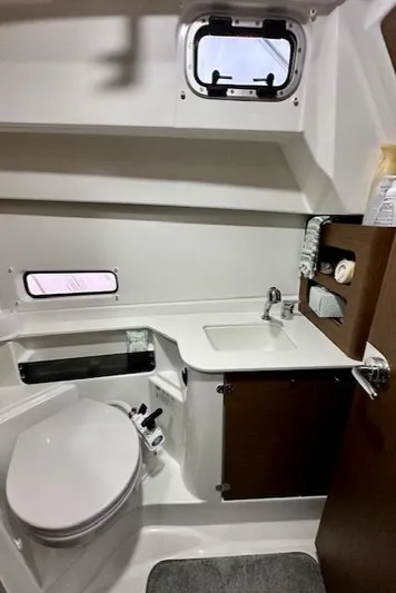  Yacht Photos Pics 2019 Beneteau Antares 27 bathroom with toilet, sink, and storage.