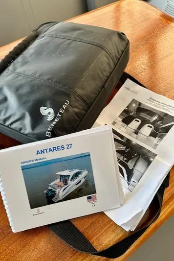  Yacht Photos Pics Beneteau Antares 27 owner's manual and bag on wooden table, 2019 model.