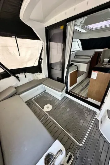  Yacht Photos Pics 2019 Beneteau Antares 27 interior with seating, modern design, and wood accents.