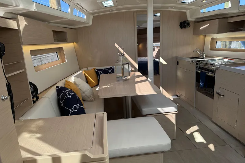 Show Boat! Special Pricing Yacht Photos Pics Modern interior of 2024 Beneteau Oceanis 37.1 yacht, featuring sleek design and cozy seating area.