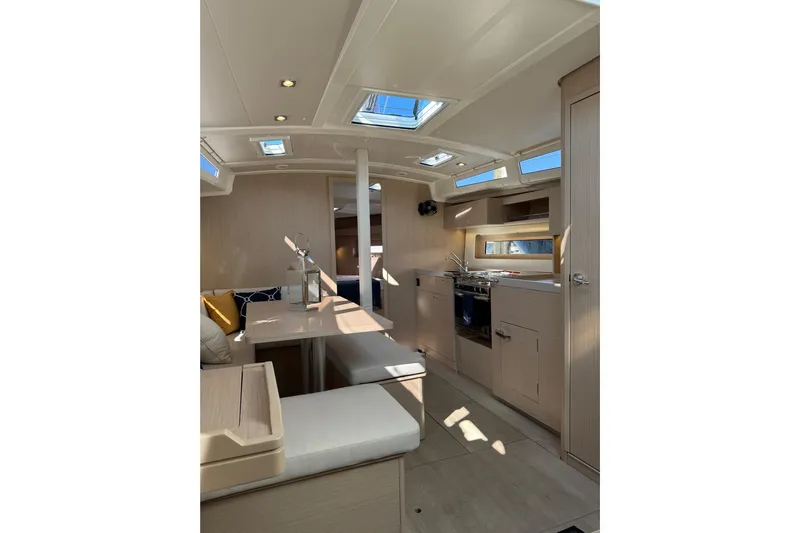 Show Boat! Special Pricing Yacht Photos Pics Interior of 2024 Beneteau Oceanis 37.1 yacht, featuring modern kitchen and seating area.