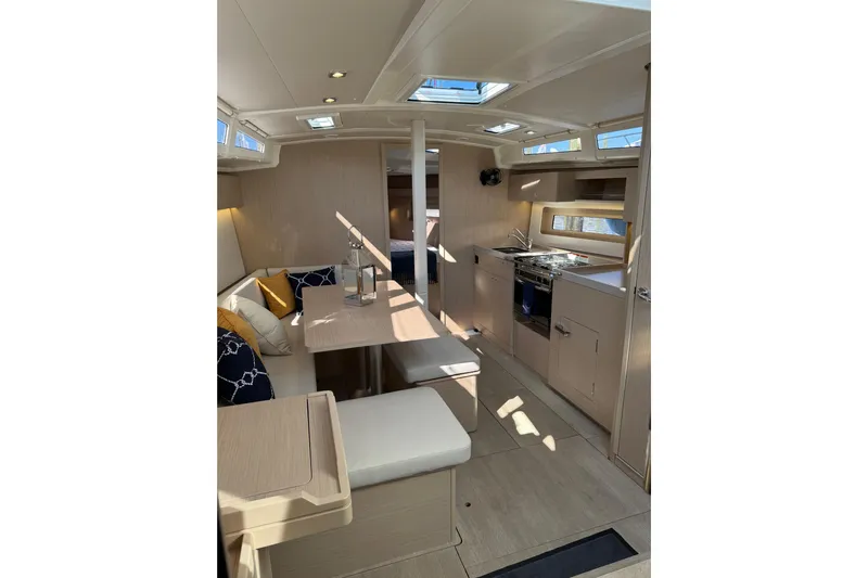 Show Boat! Special Pricing Yacht Photos Pics 2024 Beneteau Oceanis 37.1 yacht interior with modern kitchen and seating area.