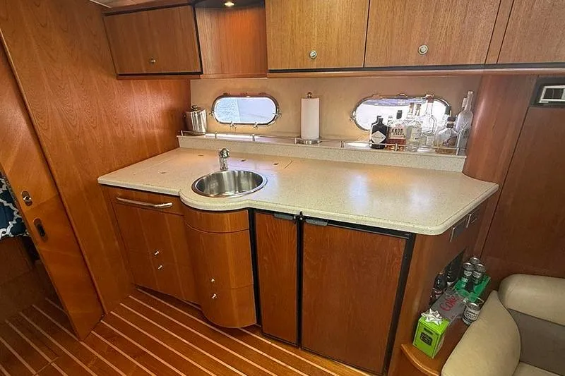 Ritz Karllton Too Yacht Photos Pics 2008 Tiara Yachts 3900 Sovran galley with wood cabinetry, sink, and countertop.