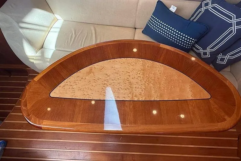 Ritz Karllton Too Yacht Photos Pics Luxurious wooden table on 2008 Tiara Yachts 3900 Sovran, with elegant seating and cushions.