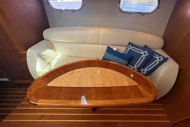 Ritz Karllton Too Yacht Photos Pics 2008 Tiara Yachts 3900 Sovran interior with elegant wood table and plush seating.