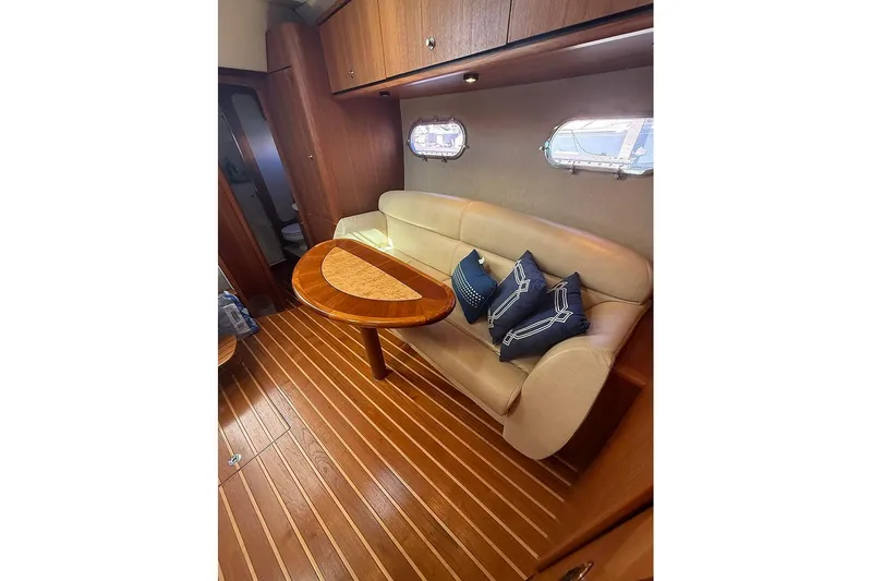 Ritz Karllton Too Yacht Photos Pics Interior of 2008 Tiara Yachts 3900 Sovran with elegant seating and wooden table.