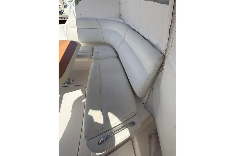 Ritz Karllton Too Yacht Photos Pics 2008 Tiara Yachts 3900 Sovran interior with white leather seating and wooden table.