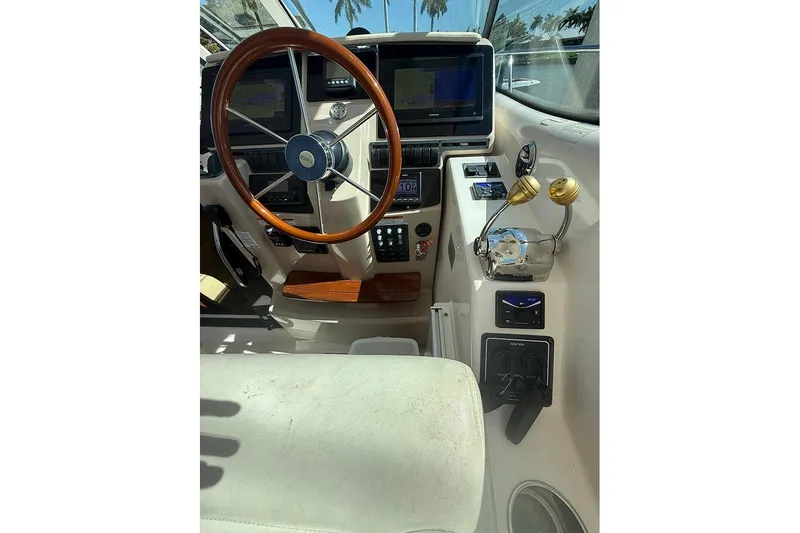Ritz Karllton Too Yacht Photos Pics 2008 Tiara Yachts 3900 Sovran helm with wooden steering wheel and navigation displays.