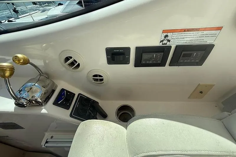 Ritz Karllton Too Yacht Photos Pics 2008 Tiara Yachts 3900 Sovran helm controls and dashboard with warning label.