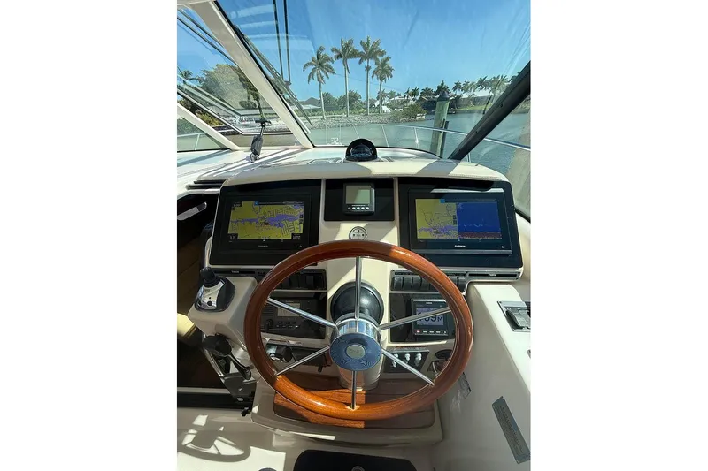 Ritz Karllton Too Yacht Photos Pics 2008 Tiara Yachts 3900 Sovran helm with dual navigation screens and wooden steering wheel.