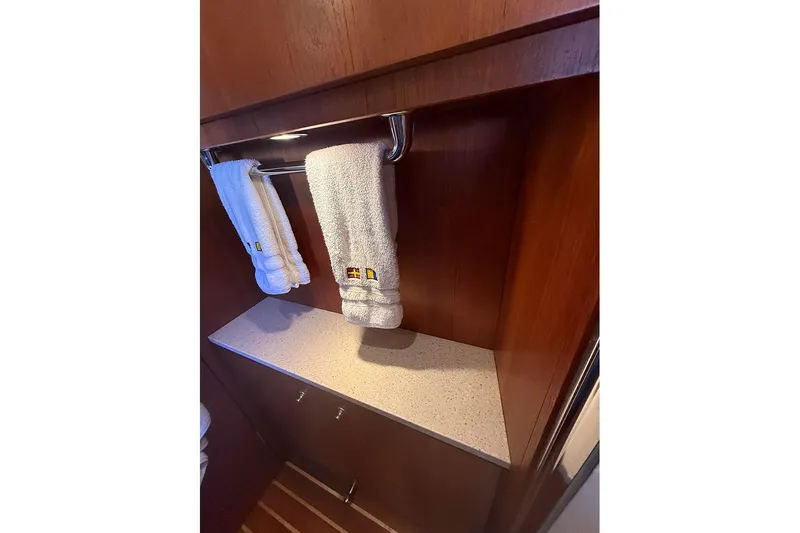 Ritz Karllton Too Yacht Photos Pics 2008 Tiara Yachts 3900 Sovran interior with wooden cabinetry and towel rack.