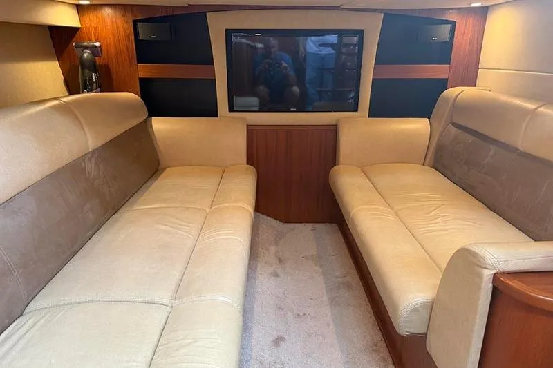 Ritz Karllton Too Yacht Photos Pics Interior of 2008 Tiara Yachts 3900 Sovran with beige seating and a flat-screen TV.