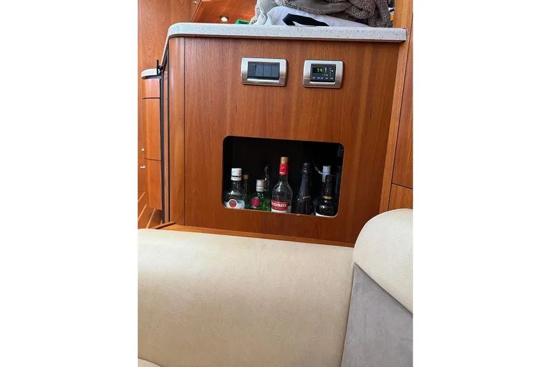 Ritz Karllton Too Yacht Photos Pics Interior of 2008 Tiara Yachts 3900 Sovran with wooden cabinet and liquor storage.