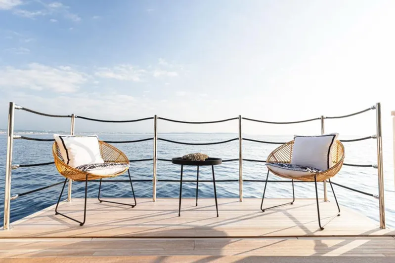 Newal Yacht Photos Pics Deck view from 2018 Custom Line Navetta 33 yacht with chairs and table overlooking the sea.