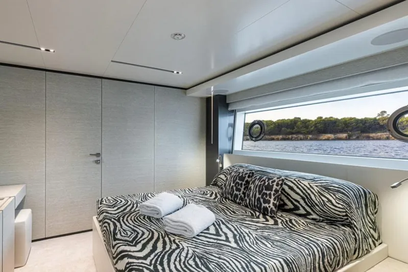 Newal Yacht Photos Pics Luxurious bedroom on 2018 Custom Line Navetta 33 yacht with zebra-patterned bedding and scenic window view.