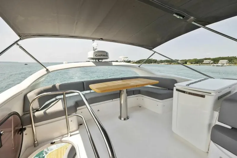 Yacht Photos Pics Luxurious 2018 Princess F49 yacht interior with seating and table, overlooking serene waters.