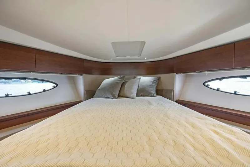  Yacht Photos Pics Luxurious cabin interior of 2018 Princess F49 yacht with cozy bedding.