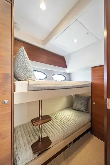  Yacht Photos Pics Bunk beds in 2018 Princess F49 yacht cabin with modern wood finish and cozy bedding.