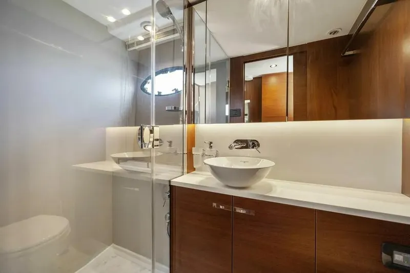  Yacht Photos Pics Luxurious bathroom in 2018 Princess F49 yacht with modern fixtures and elegant wood cabinetry.