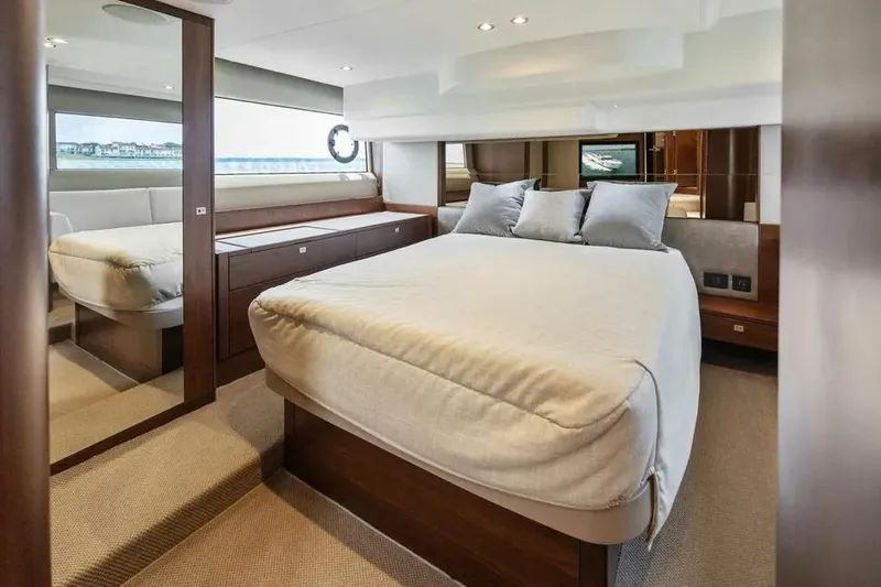 Yacht Photos Pics Luxurious cabin interior of 2018 Princess F49 yacht with elegant bedding and modern design.
