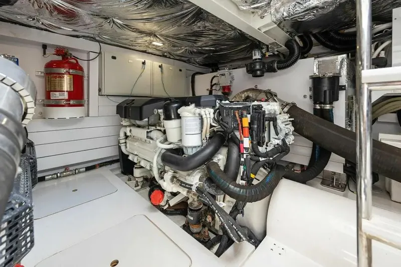  Yacht Photos Pics Engine room of 2018 Princess F49 yacht, featuring modern equipment and fire extinguisher.