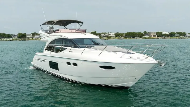  Yacht Photos Pics 2018 Princess F49 yacht cruising on calm waters near a coastal town.