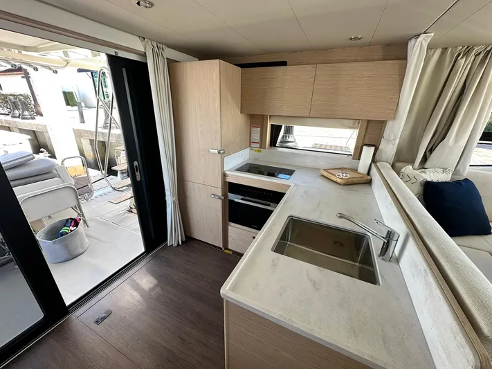 My Ty Yacht Photos Pics 2023 Beneteau Swift Trawler 48 interior kitchen with modern design and sleek finishes.
