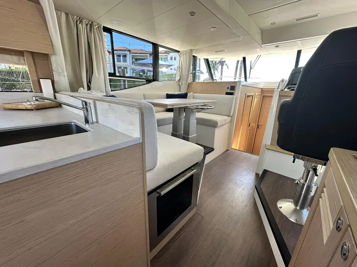 My Ty Yacht Photos Pics Interior of 2023 Beneteau Swift Trawler 48, featuring modern seating and helm station.