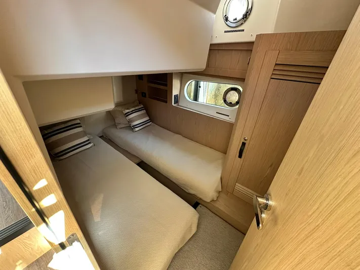 My Ty Yacht Photos Pics 2023 Beneteau Swift Trawler 48 cabin with twin beds and modern wood finish.