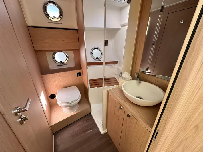 My Ty Yacht Photos Pics 2023 Beneteau Swift Trawler 48 bathroom with modern fixtures and wooden accents.