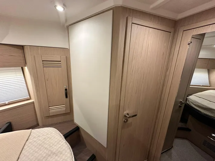 My Ty Yacht Photos Pics 2023 Beneteau Swift Trawler 48 interior cabin with modern wood finish and cozy design.