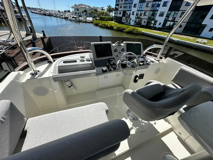 My Ty Yacht Photos Pics 2023 Beneteau Swift Trawler 48 helm with modern controls, docked at marina.