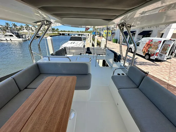 My Ty Yacht Photos Pics 2023 Beneteau Swift Trawler 48, spacious deck with seating, docked at marina.