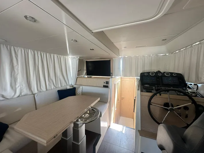 My Ty Yacht Photos Pics 2023 Beneteau Swift Trawler 48 interior with helm, dining area, and modern furnishings.