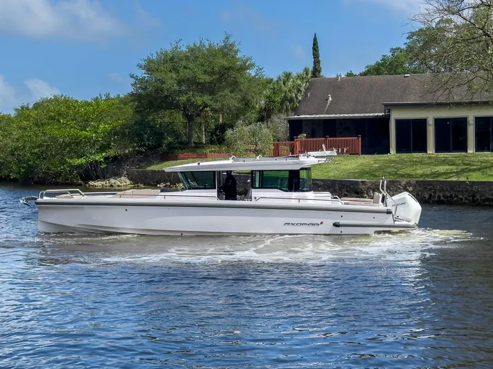 Yacht Photos Pics 2024 Axopar 37XC CROSS CABIN BRABUS Trim cruising on a serene river.