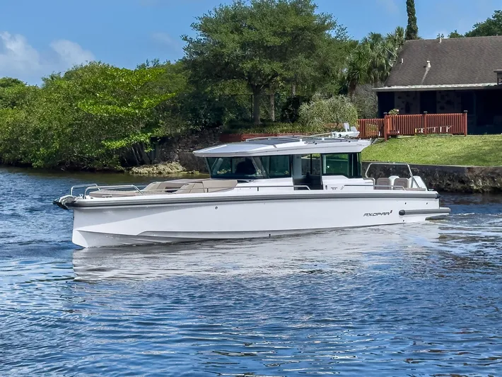  Yacht Photos Pics 2024 Axopar 37XC CROSS CABIN BRABUS Trim cruising on a serene waterway.