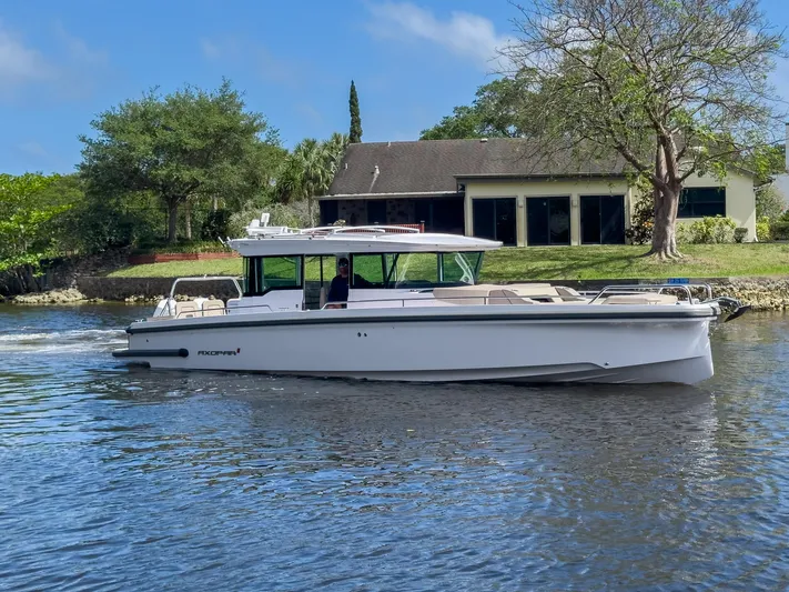  Yacht Photos Pics 2024 Axopar 37XC CROSS CABIN BRABUS Trim boat on a serene waterway.