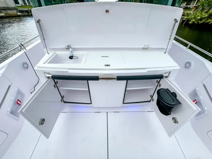  Yacht Photos Pics 2024 Axopar 37XC CROSS CABIN BRABUS Trim boat kitchen with sink and storage.