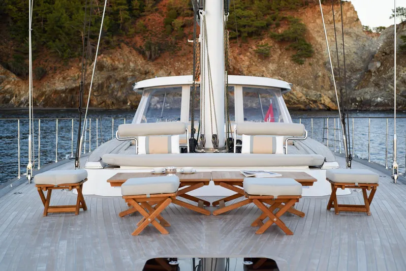 Mishi Yacht Photos Pics Luxurious Custom Mishi 88 yacht deck with seating, 2018 model, scenic coastal backdrop.