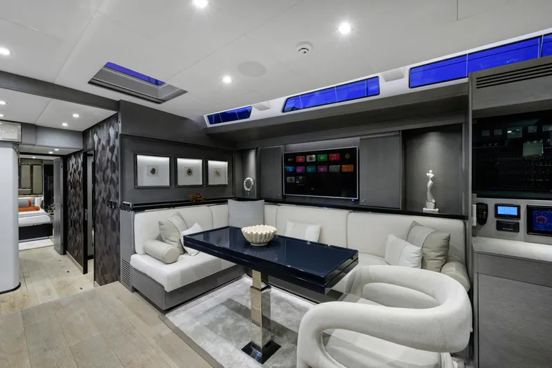 Mishi Yacht Photos Pics Luxurious yacht interior with modern seating, sleek table, and ambient lighting, Custom Mishi 88, 2018.