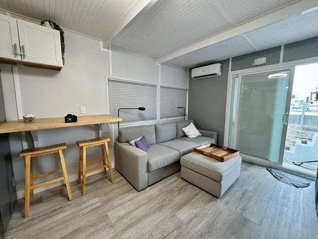  Yacht Photos Pics Modern Struktures MS 400 interior, 2023 model, featuring cozy living space with sofa and bar stools.