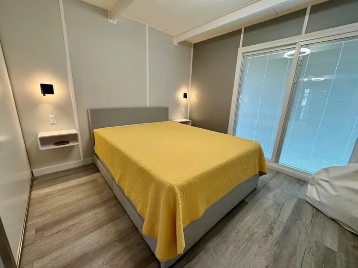  Yacht Photos Pics Modern bedroom with yellow bedspread, sleek design, and ambient lighting, 2023 Modern Struktures MS 400.