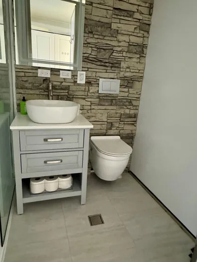  Yacht Photos Pics Modern bathroom with stone accent wall, sleek vanity, and wall-mounted toilet, 2023 Modern Struktures MS 400.