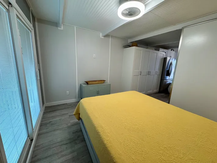  Yacht Photos Pics Modern bedroom with yellow bedding, sleek design, and ample storage in a 2023 Modern Struktures MS 400.