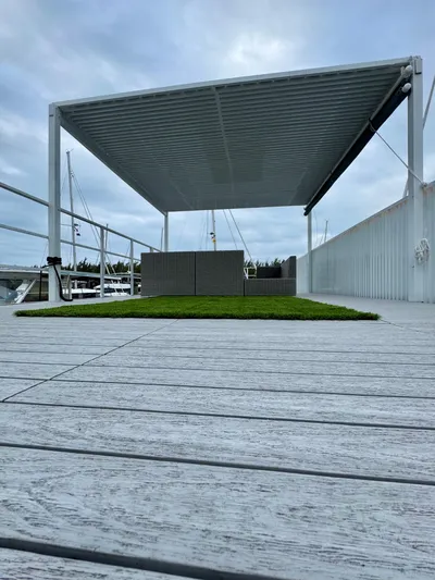  Yacht Photos Pics Modern Struktures MS 400 pergola on a wooden deck, 2023 model, with overcast sky.