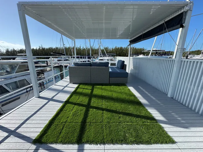  Yacht Photos Pics Modern Struktures MS 400 rooftop deck with pergola, artificial grass, and outdoor seating, 2023 model.