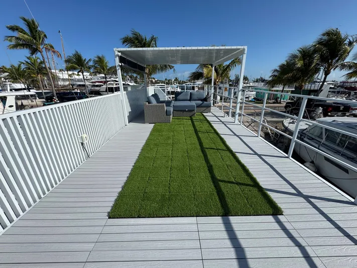  Yacht Photos Pics Rooftop deck with artificial grass, modern seating, and palm trees, by Modern Struktures MS 400, 2023.